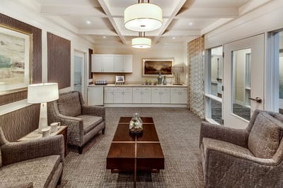 Bright common area with seating and kitchenette