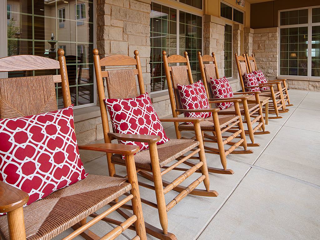 Rocking chairs with decorative pillows on a porch