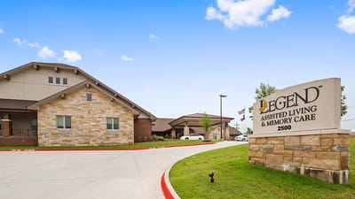 Exterior view of Legend assisted living facility with signage