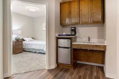 A view of a cozy resident room with kitchenette