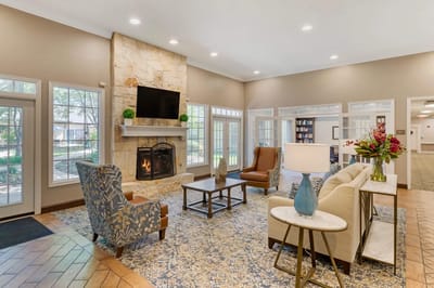 Bright common area with seating and a fireplace