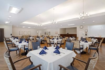 Dining room set for a meal with blue napkins