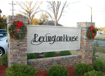 Exterior sign for Lexington House with holiday decorations