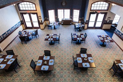 Dining room setup with tables and chairs ready for meals