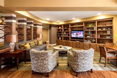 Cozy common area in a senior living facility with seating and decor