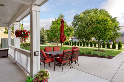 Outdoor seating area with tables and landscaping