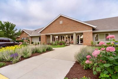 Front entrance of Library Terrace Apartment with vibrant flowers