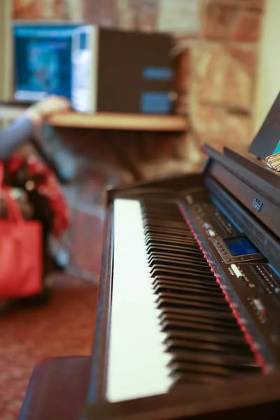 Digital piano in an activity room with a computer