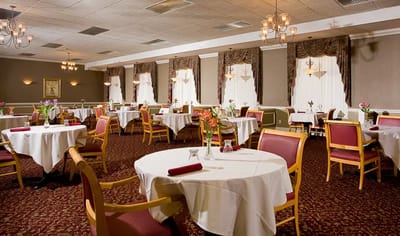 Elegant dining room setup with tables and flowers