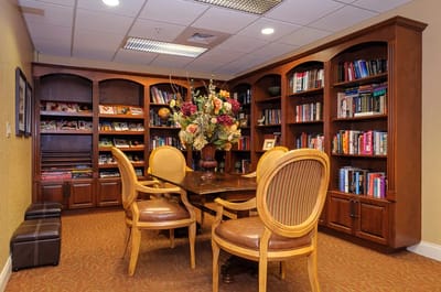A cozy reading area with bookshelves and a table