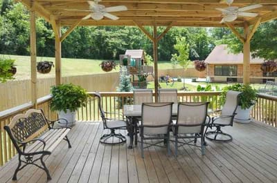 Outdoor patio area with seating and greenery