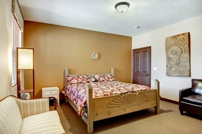 Cozy, well-decorated room with a bed and seating area
