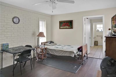 Private resident room with bed and small table