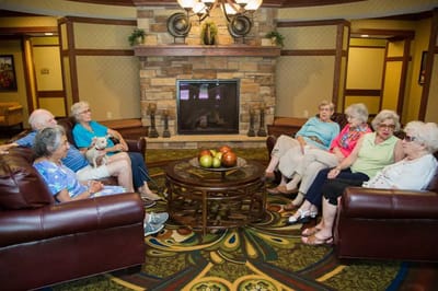 Residents seated in a common area chatting together