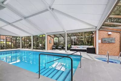 Indoor swimming pool area with lounge seating