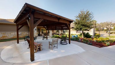 Shaded outdoor seating area with rocking chairs