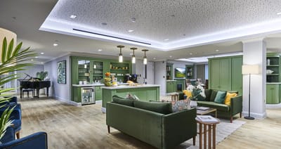 Bright, modern common area with seating and piano