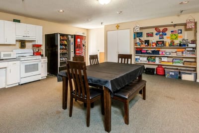 Interior view of a common area with tables and storage