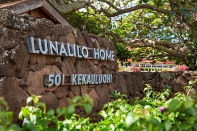 Exterior sign of Lunalilo Home amidst greenery