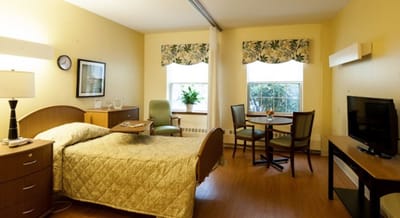 Cozy private resident room with a bed and sitting area