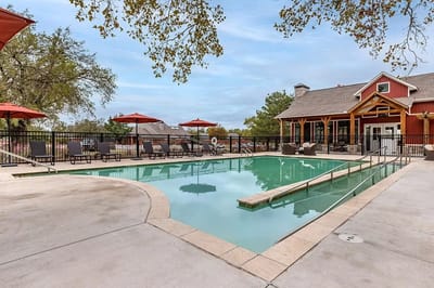 Outdoor pool with lounge chairs and umbrellas