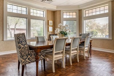Elegant dining area with large windows and floral centerpiece