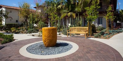 A serene outdoor space with a fountain and seating