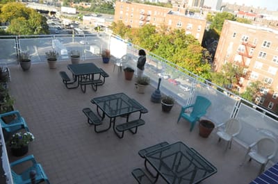 A rooftop outdoor space with seating areas