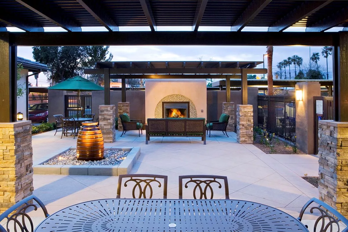 Outdoor seating area with a fireplace and fountain