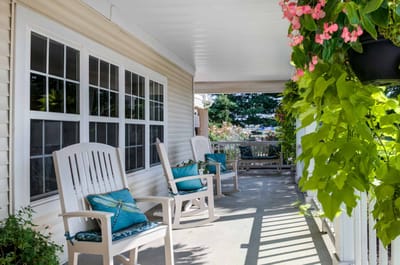 Outdoor seating area with rocking chairs and plants