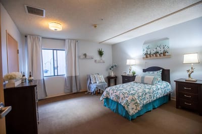 A cozy resident room with floral decor and soft lighting