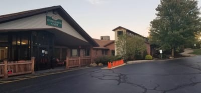 Exterior view of the rehabilitation center with pathways and trees