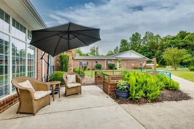 Outdoor seating area with a garden and umbrella