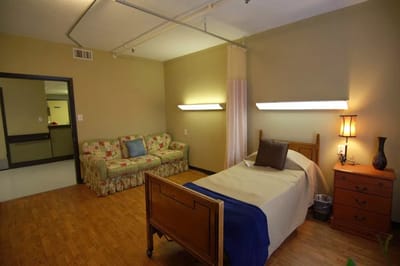 Private resident room with bed and seating area