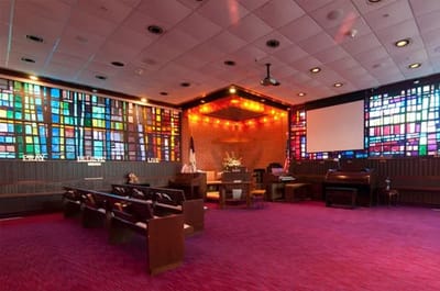 Interior view of a chapel with stained glass windows