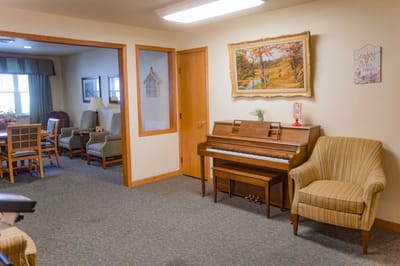 Interior view of a cozy lounge area with a piano