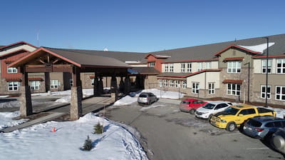 Exterior view of Maple Springs of Anchorage with parking area