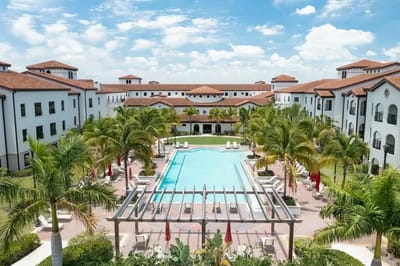 Aerial view of the facility with pool and palm trees