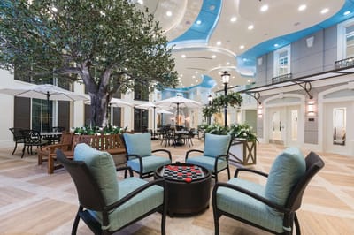 Beautiful indoor seating area with a tree and game table
