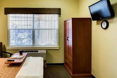Cozy resident room with furniture and a window