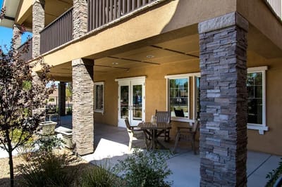 Outdoor seating area surrounded by landscaping