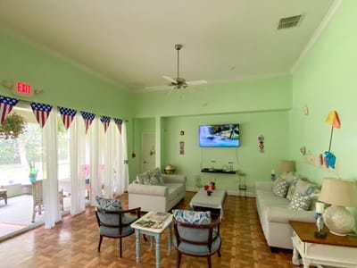 Bright common area with comfortable seating and a TV