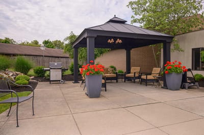 Outdoor seating area with a gazebo and flowers