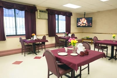 Dining room set up for a meal with flowers on the table