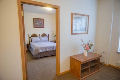 Cozy interior view of a resident room with a bed and decor