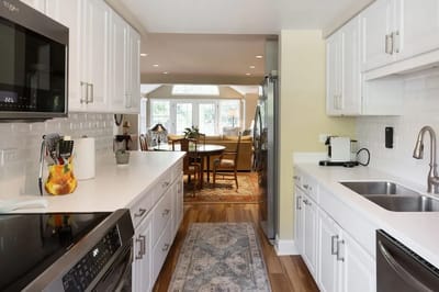 Bright kitchen area overlooking a common dining space