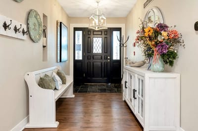 Bright interior hallway with floral decor and seating