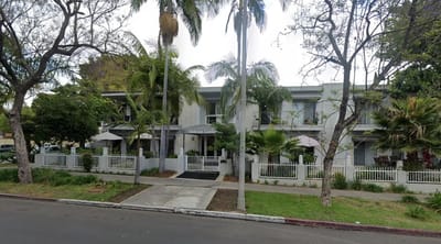Exterior view of Melrose Gardens with trees and landscaping