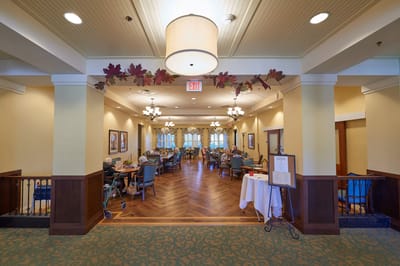 Dining area with residents socializing and exploring menus