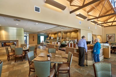 Interior view of a dining room with residents and staff